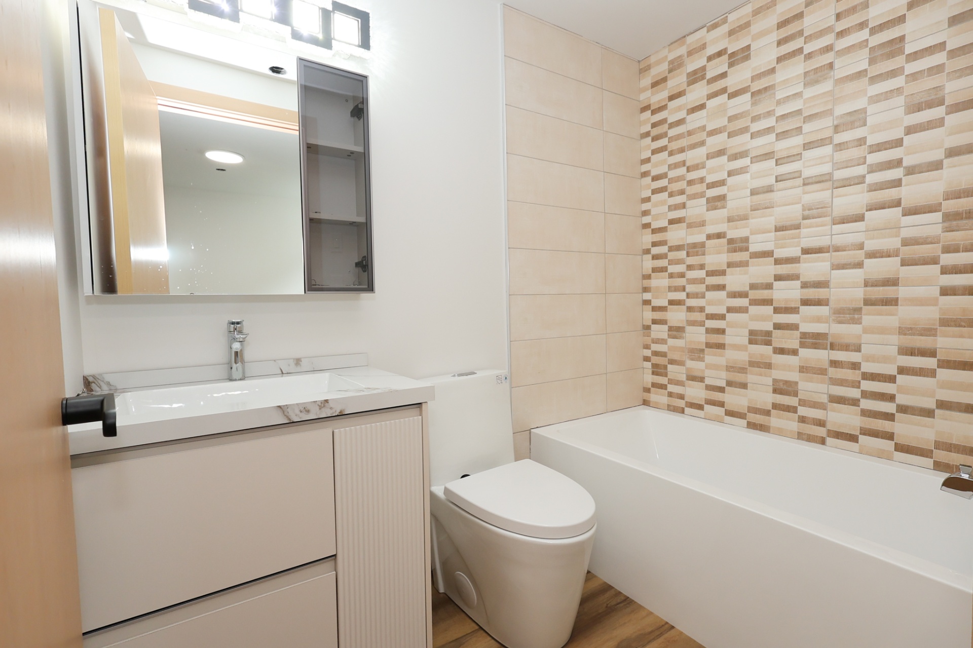 1615 Richardson Road #175 — bathroom with soaker tub and mosaic tile accent wall